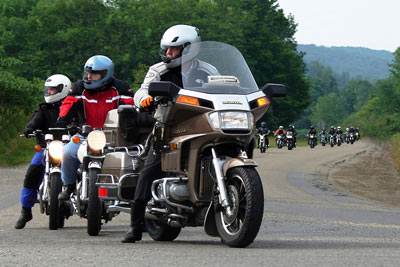 A group of motorcycle riders on a country road