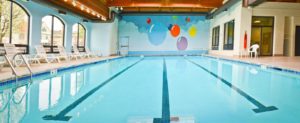Large indoor pool with deck chairs
