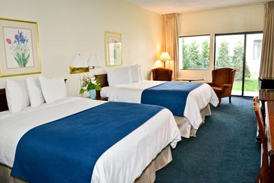 Two queen beds in a hotel room