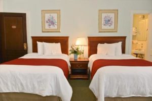 Traditionally decorated hotel room with two double beds