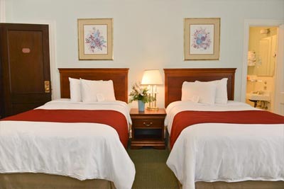 Traditionally decorated hotel room with two double beds