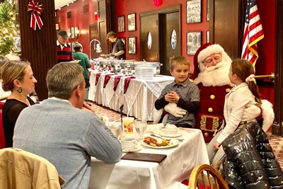 Children on Santa's lap in front of their parents
