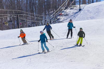 Skiers coming down a snowy slope